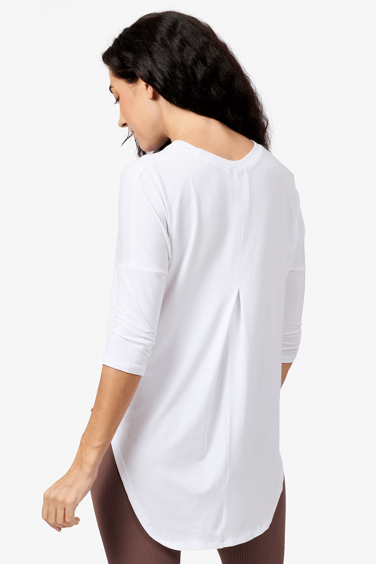 Back of a woman wearing a white 3/4 length sleeve shirt