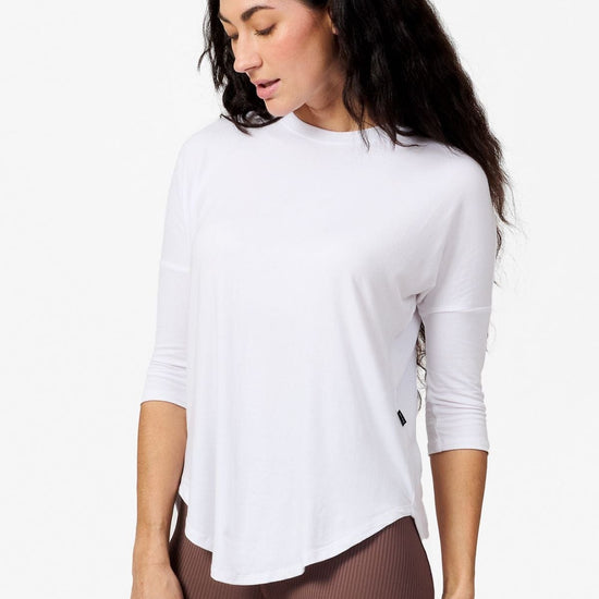 Woman wearing a white 3/4 length sleeve shirt