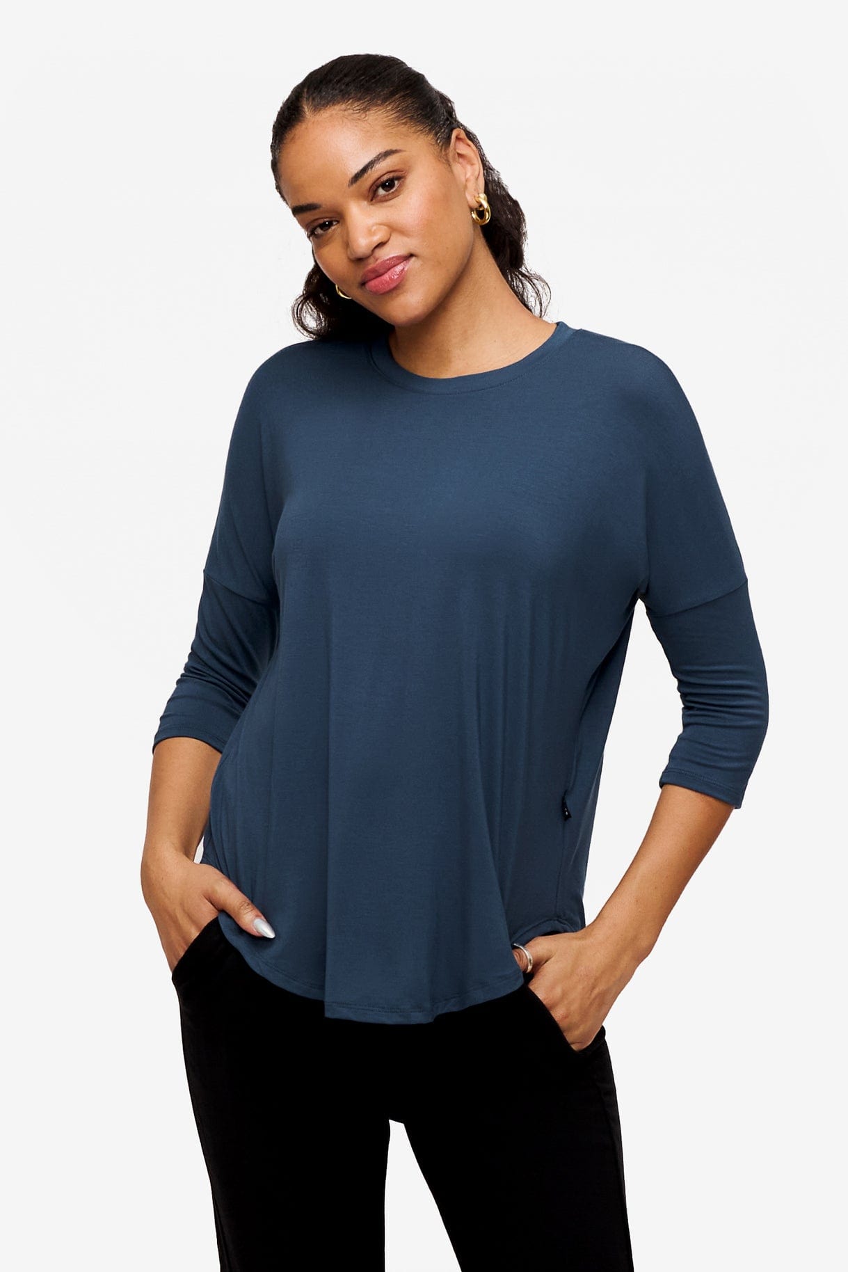 Woman wearing a bright blue 3/4 sleeve shirt