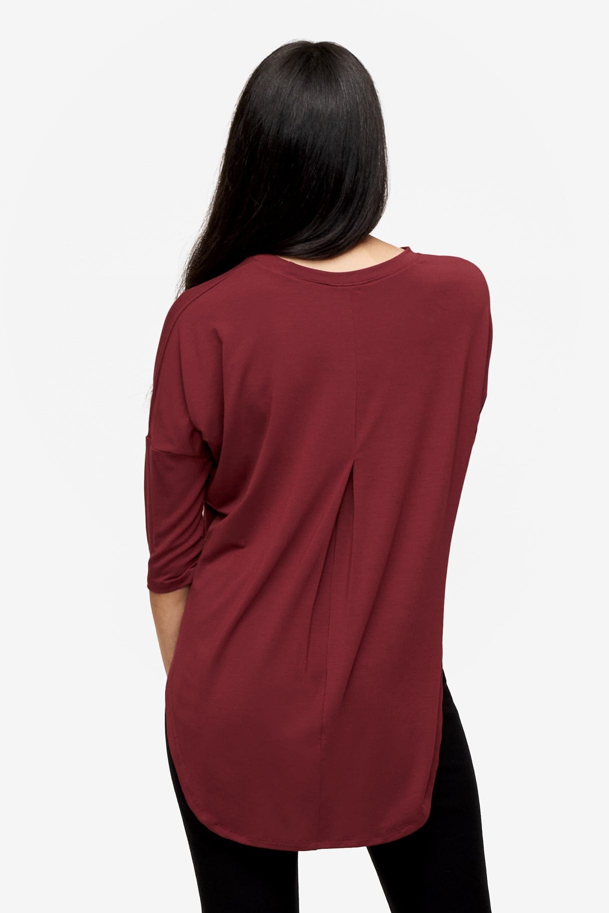 back of a Woman wearing a deep red 3/4 sleeve shirt