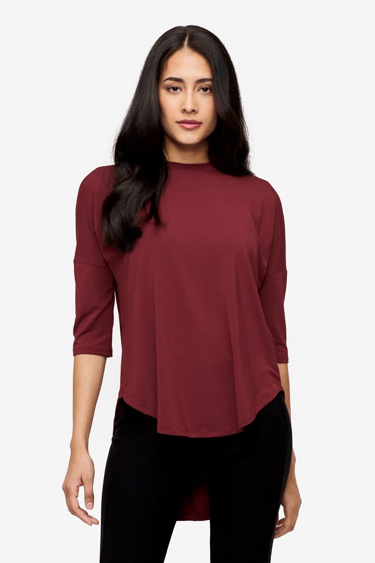 Woman wearing a deep red 3/4 sleeve shirt