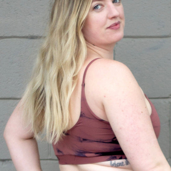 Blonde woman wearing tie-dye swim top