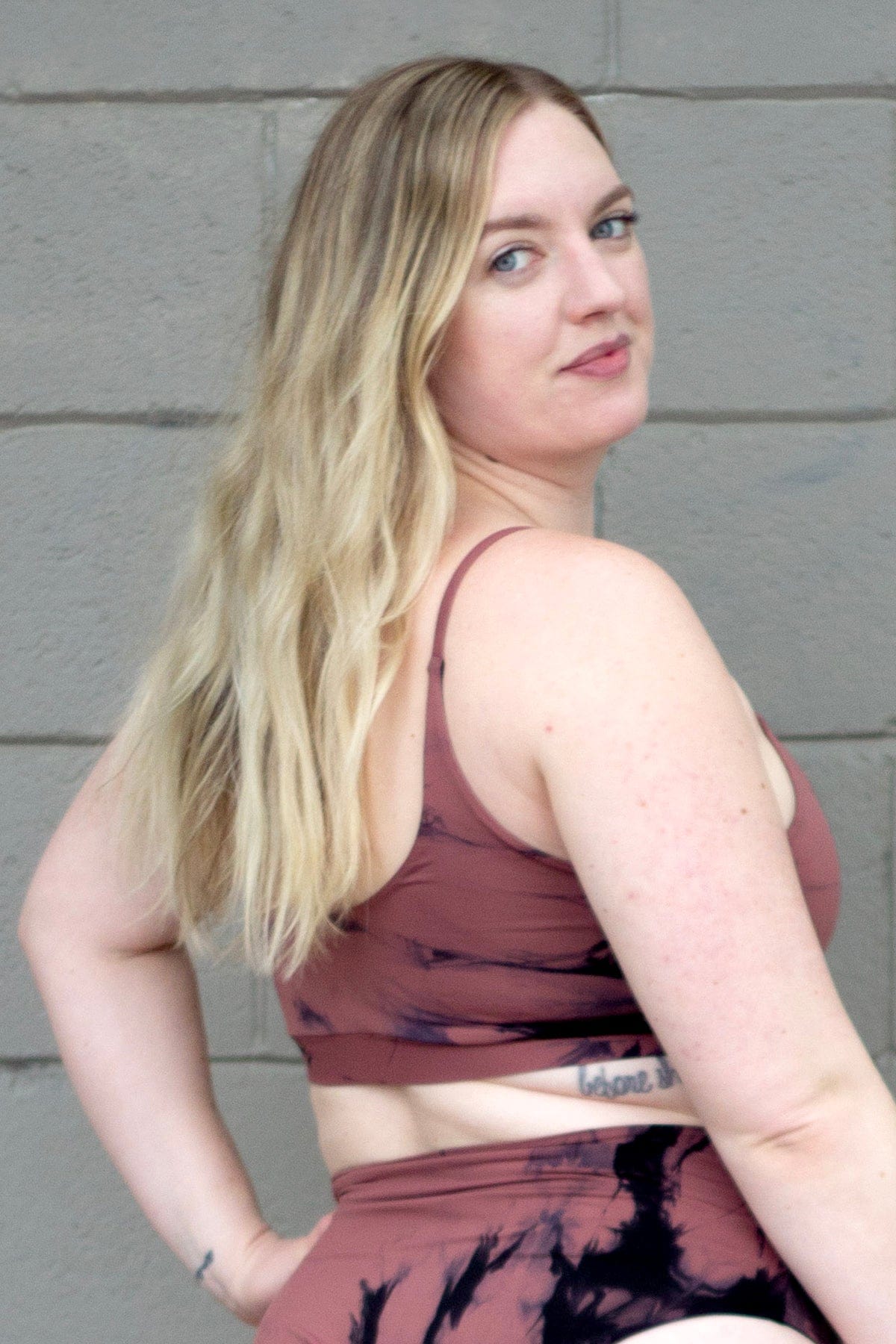 Blonde woman wearing tie-dye swim top