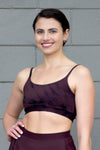 Woman smiling wearing a brown tie-dye swim top