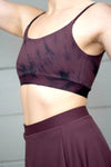 The torso of a woman wearing a swim top tie-dye