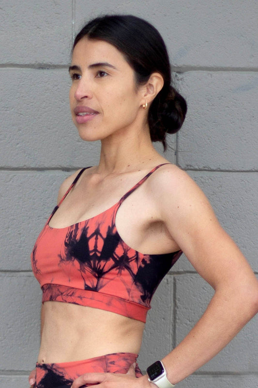 Woman wearing a orange tie-dye swim top