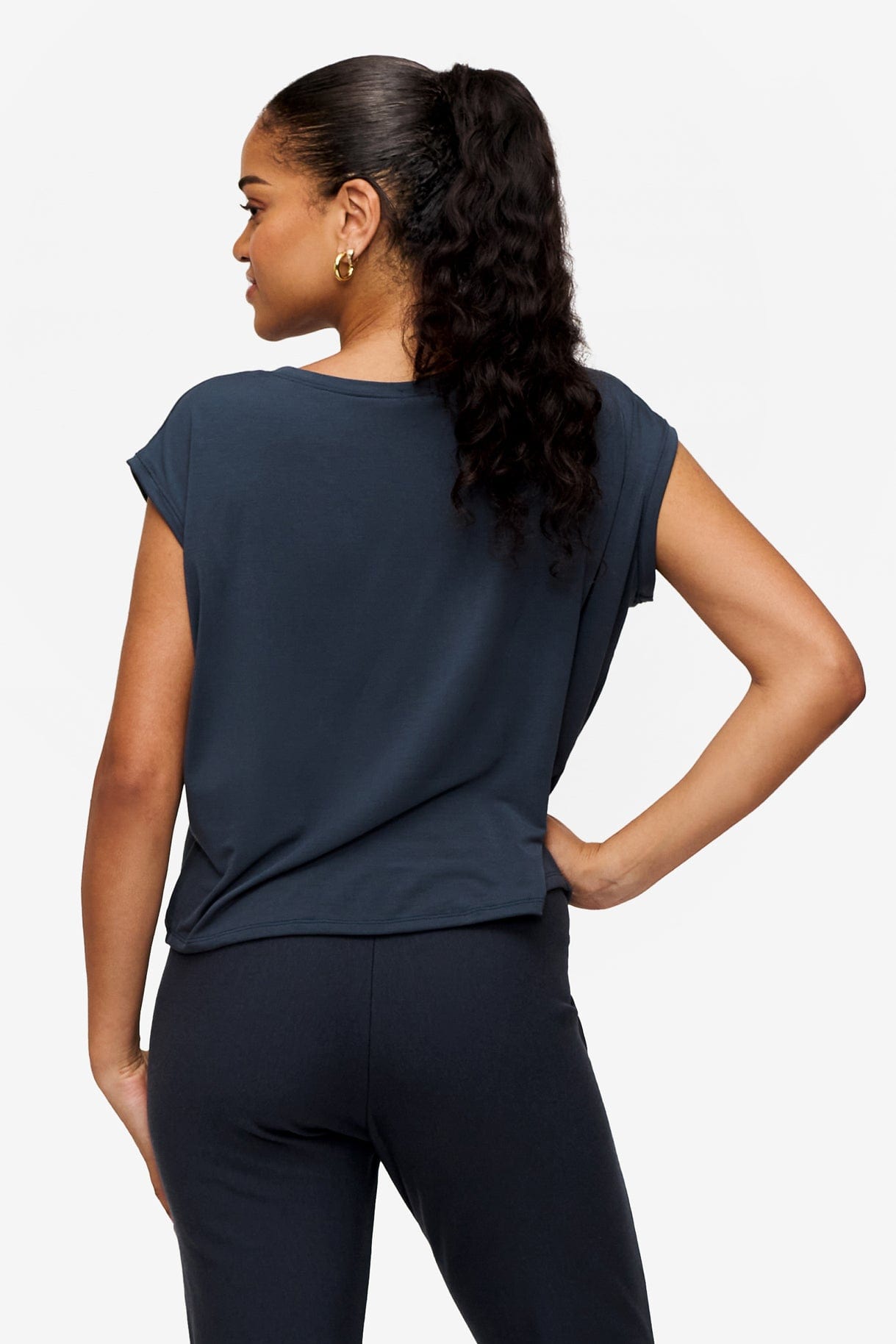 back of a woman wearing a sleeveless top in dark blue