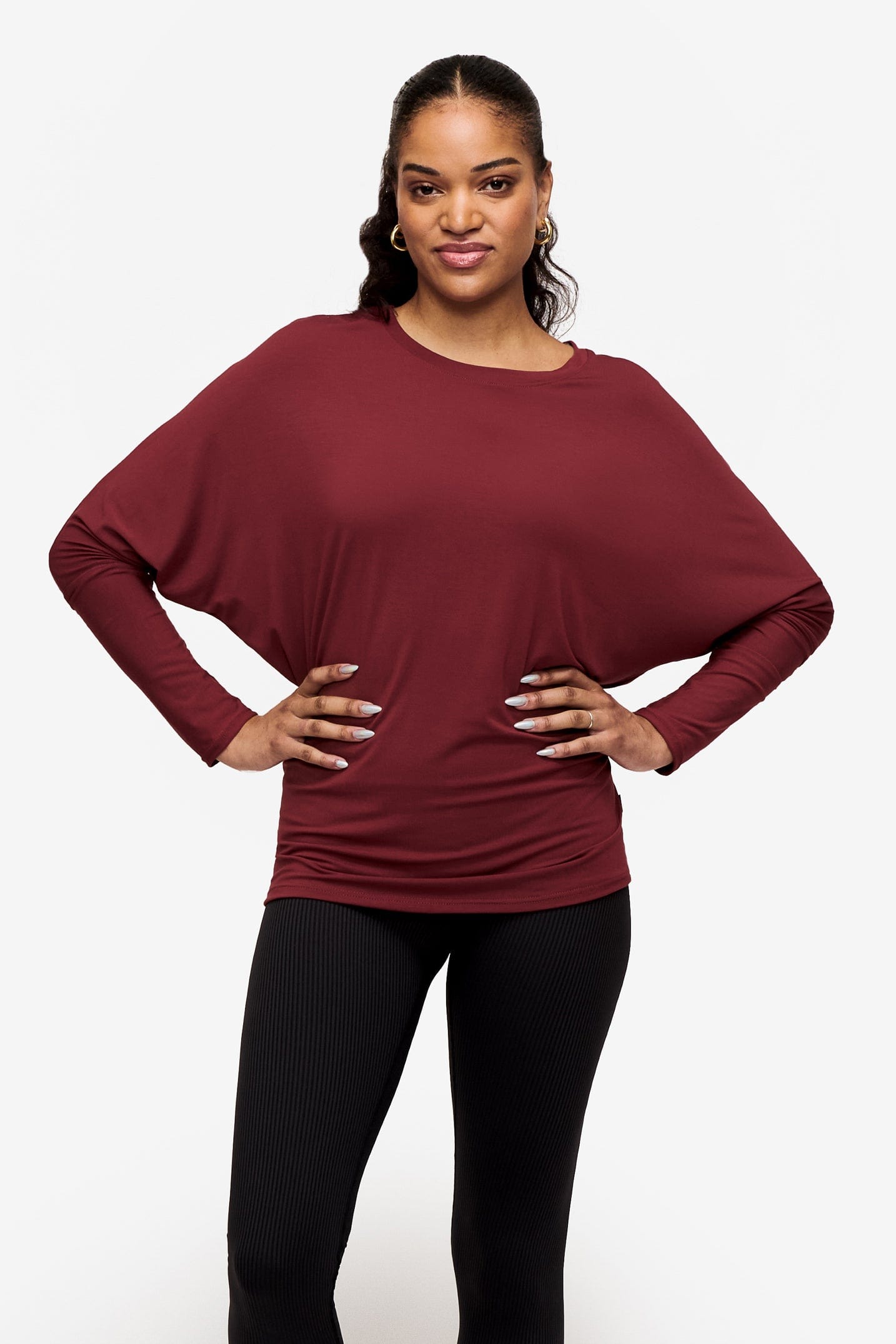 woman wearing a dark red loose sleeve long sleeve shirt