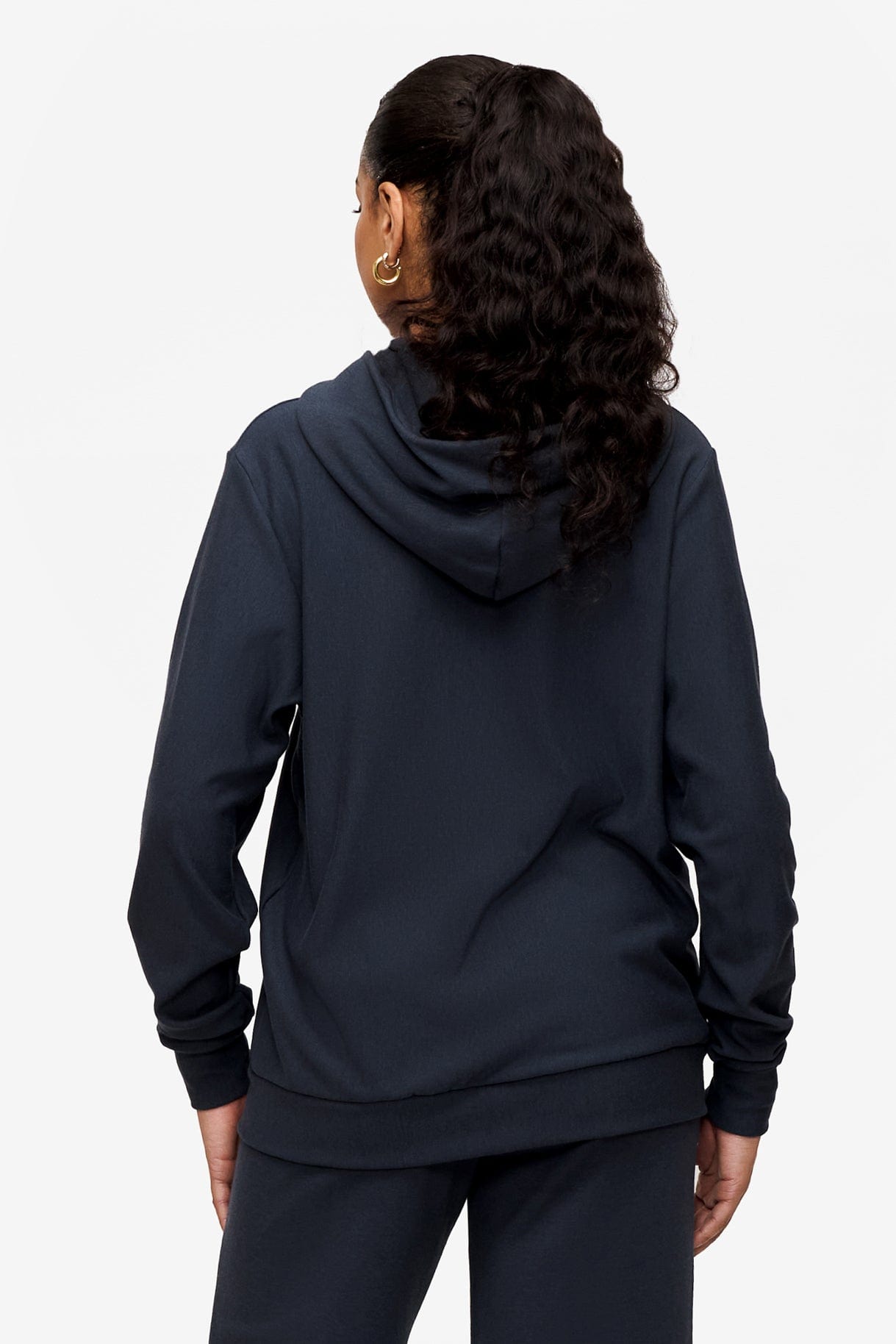 back of a woman wearing full zip hoodie in dark blue