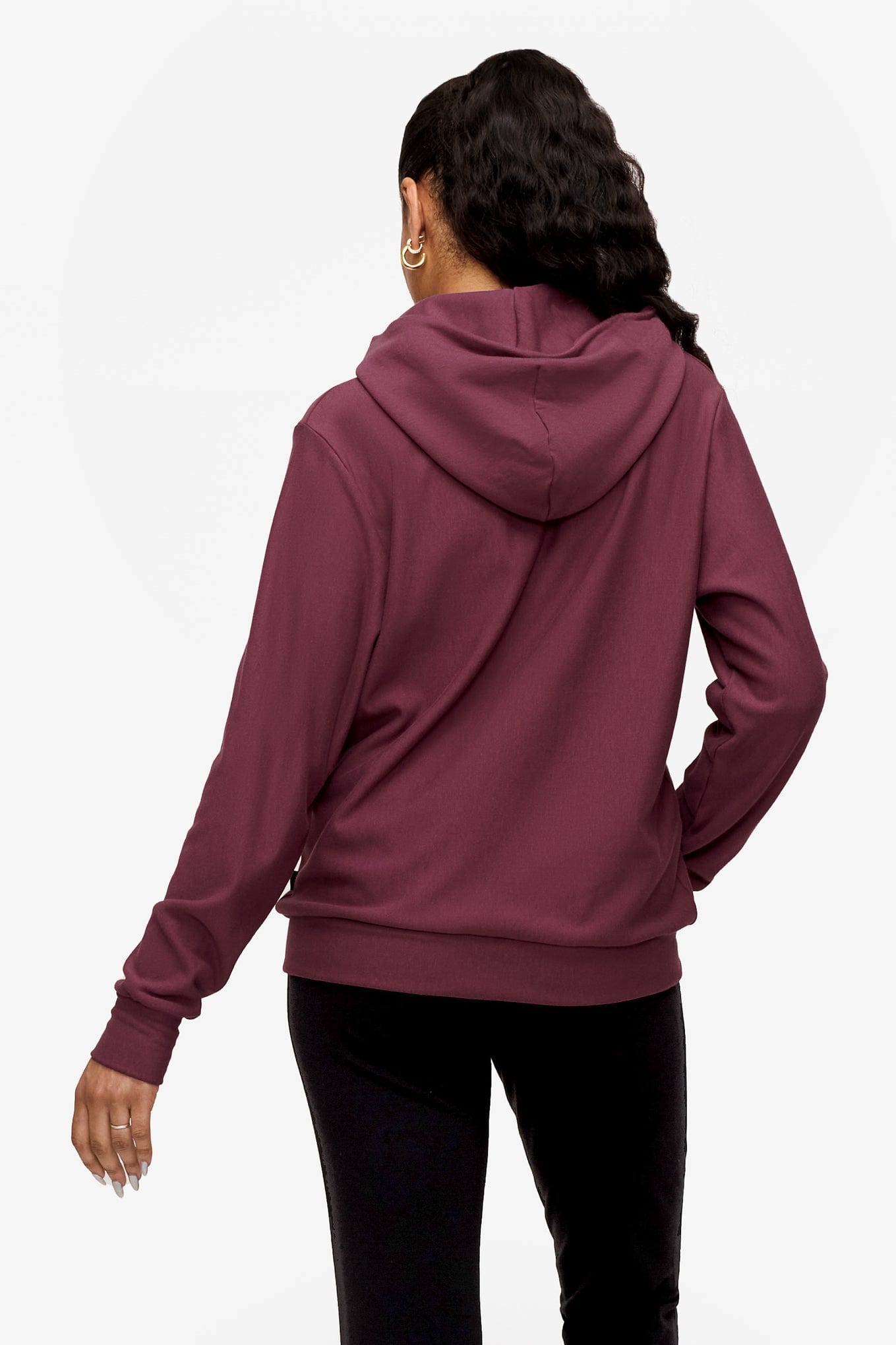back of woman wearing full zip hoodie in deep pink