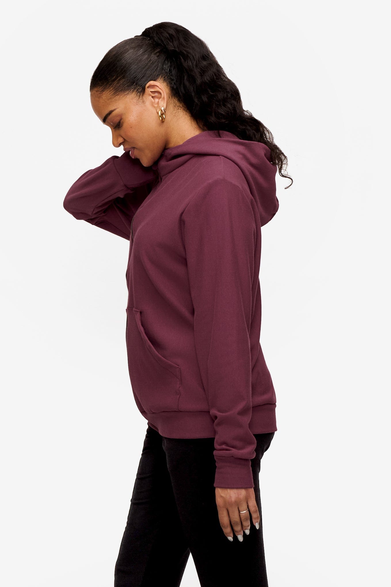 side of a woman wearing full zip hoodie in deep pink