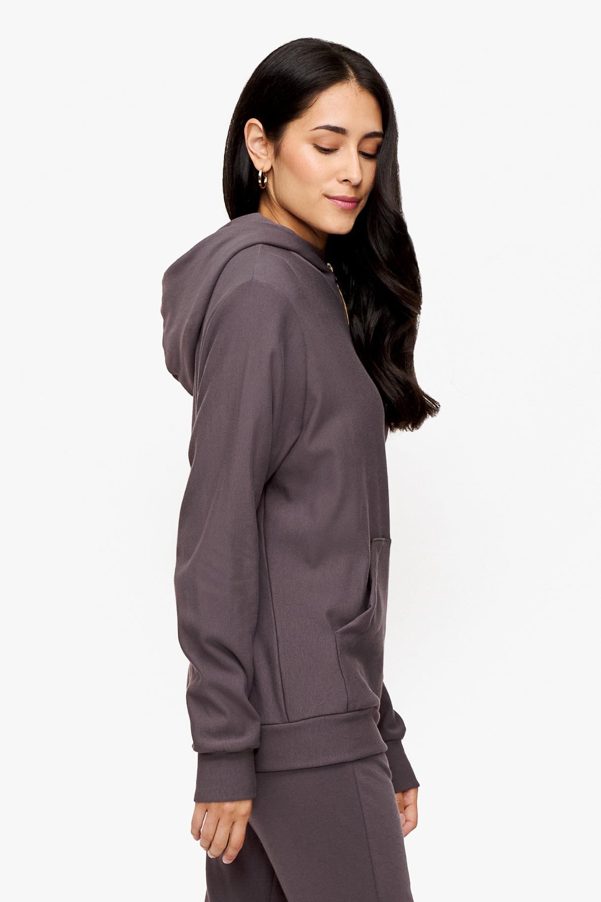 side of a woman wearing full zip hoodie in deep purple