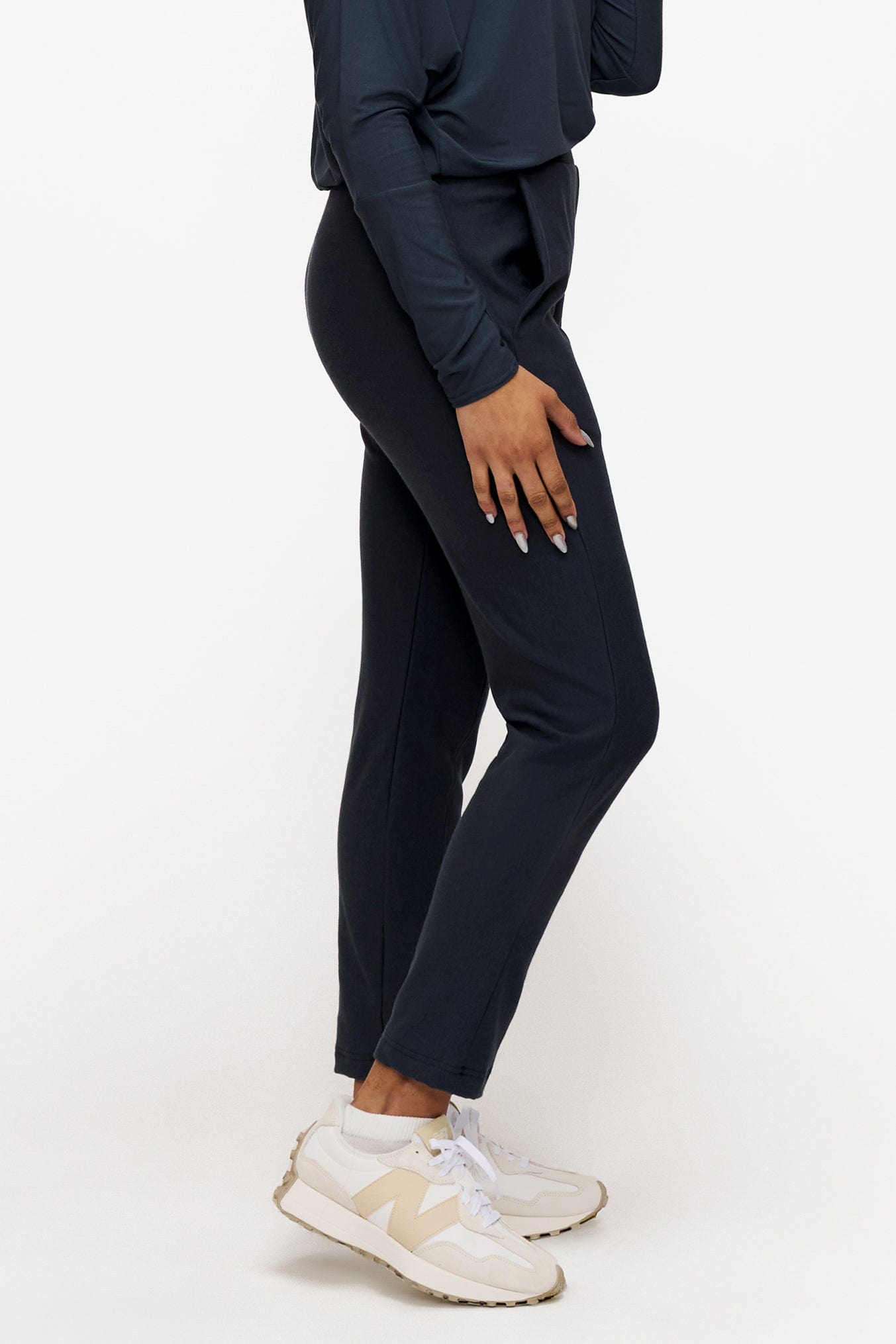 side of a woman wearing dark blue dressy pants