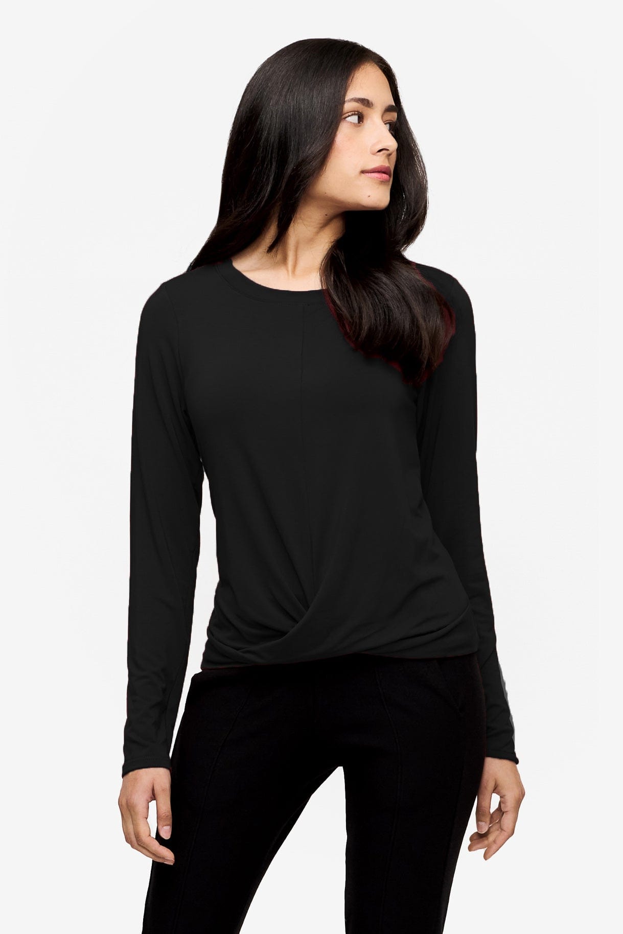 Woman wearing a black long sleeve tee with a twist in the front