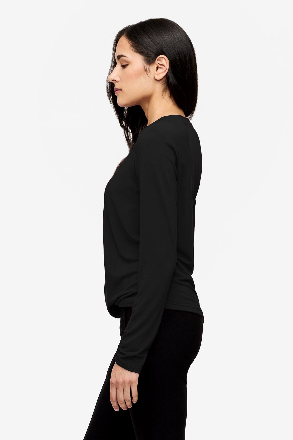 Side of a Woman wearing a black long sleeve tee with a twist in the front