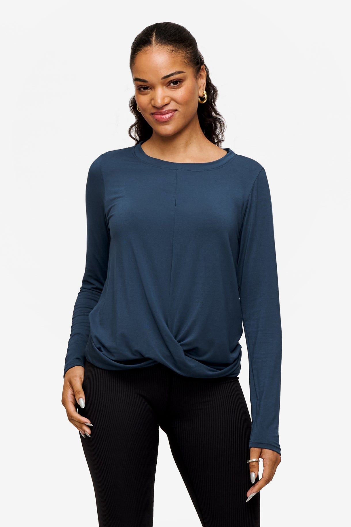 woman wearing a long sleeve shirt with a twist at the front in blue