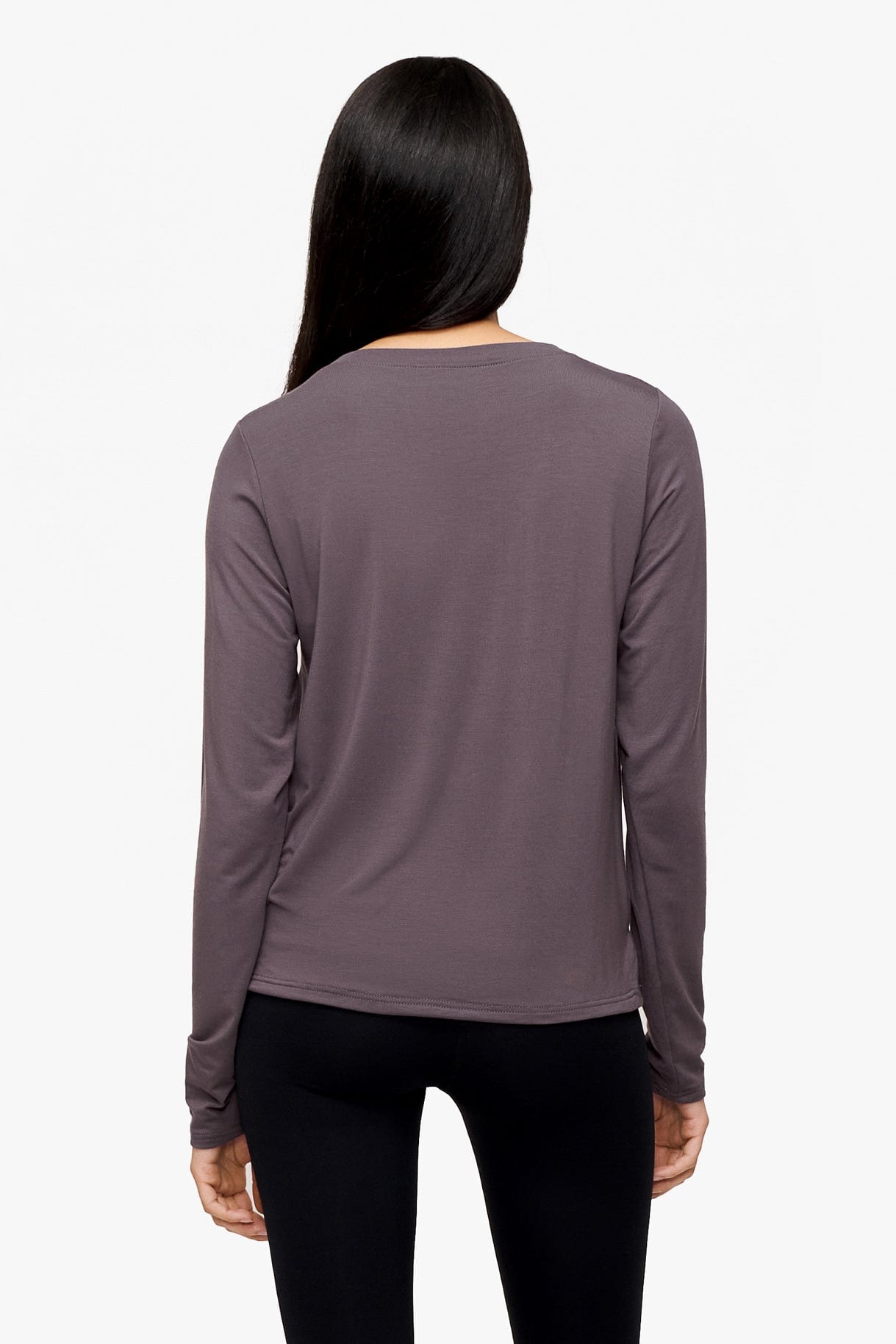 back of a woman wearing a long sleeve shirt with a twist at the front in deep purple