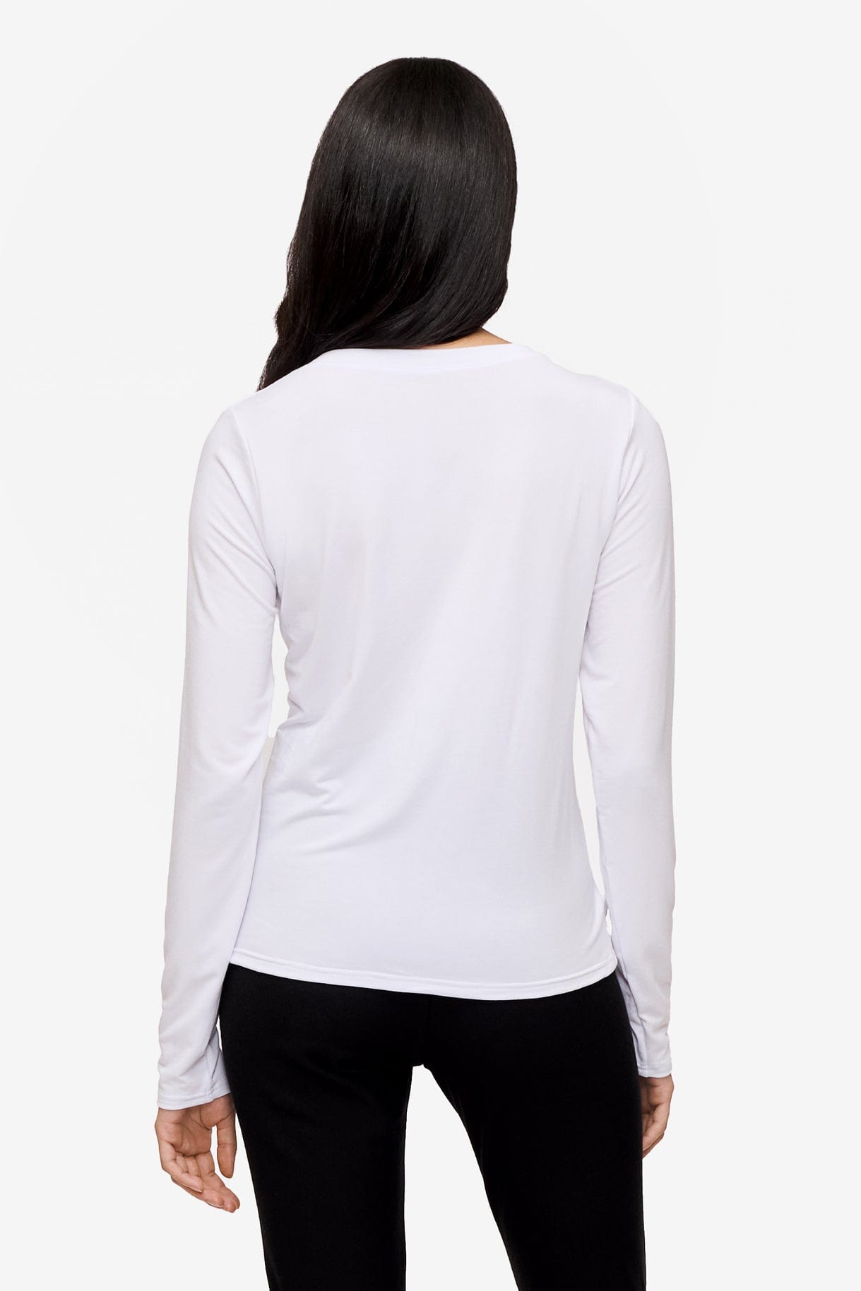 back of a woman wearing a long sleeve shirt with a twist at the front in white