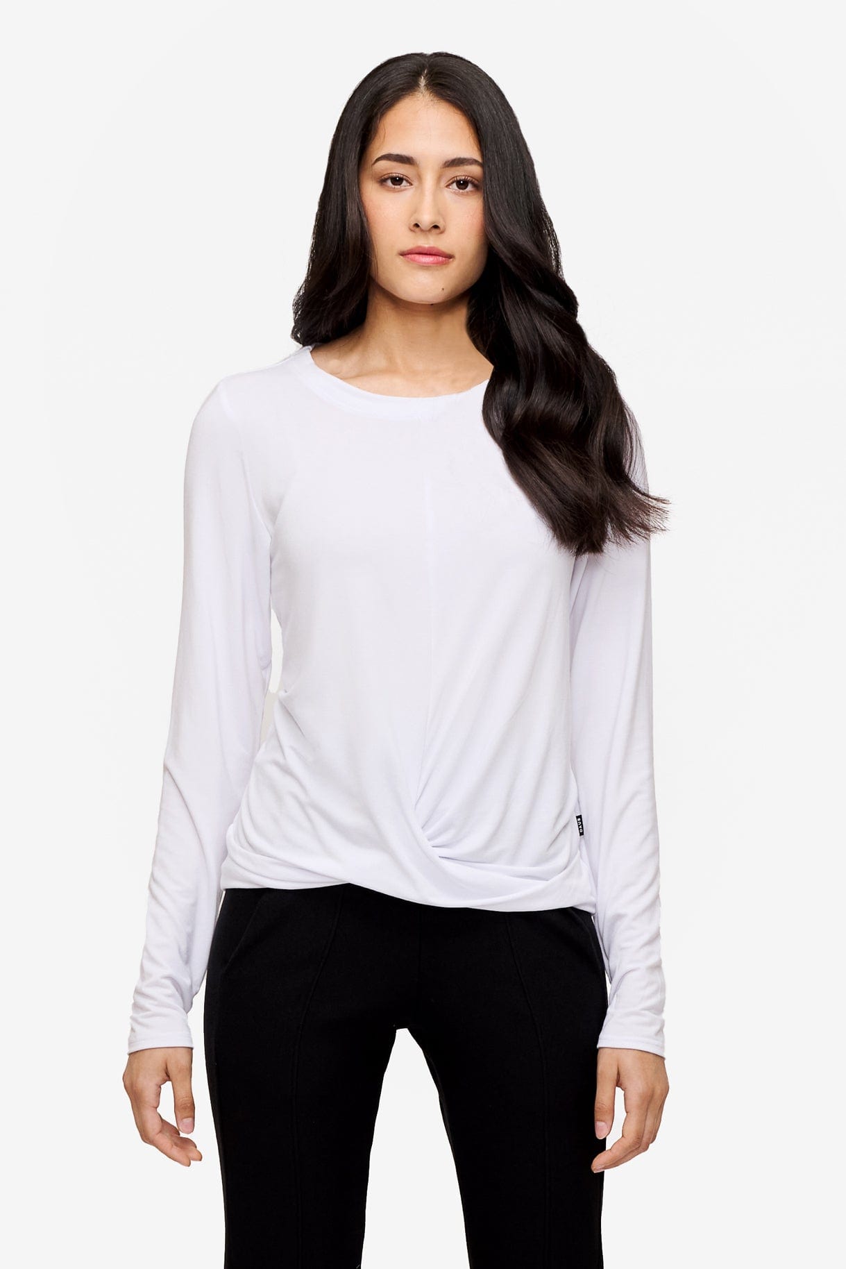 woman wearing a long sleeve shirt with a twist at the front in white