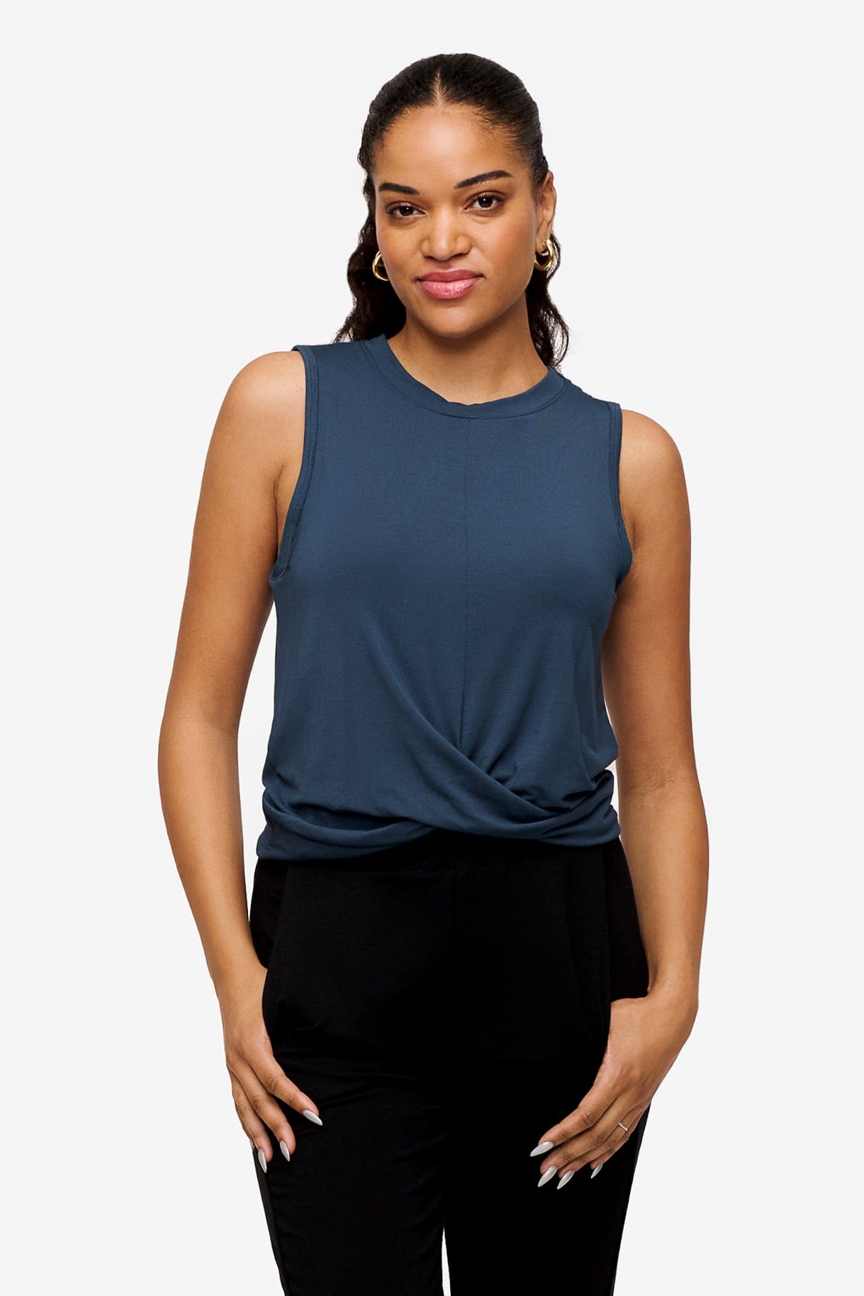 woman wearing a sleeveless shirt with a twist at the front in deep blue