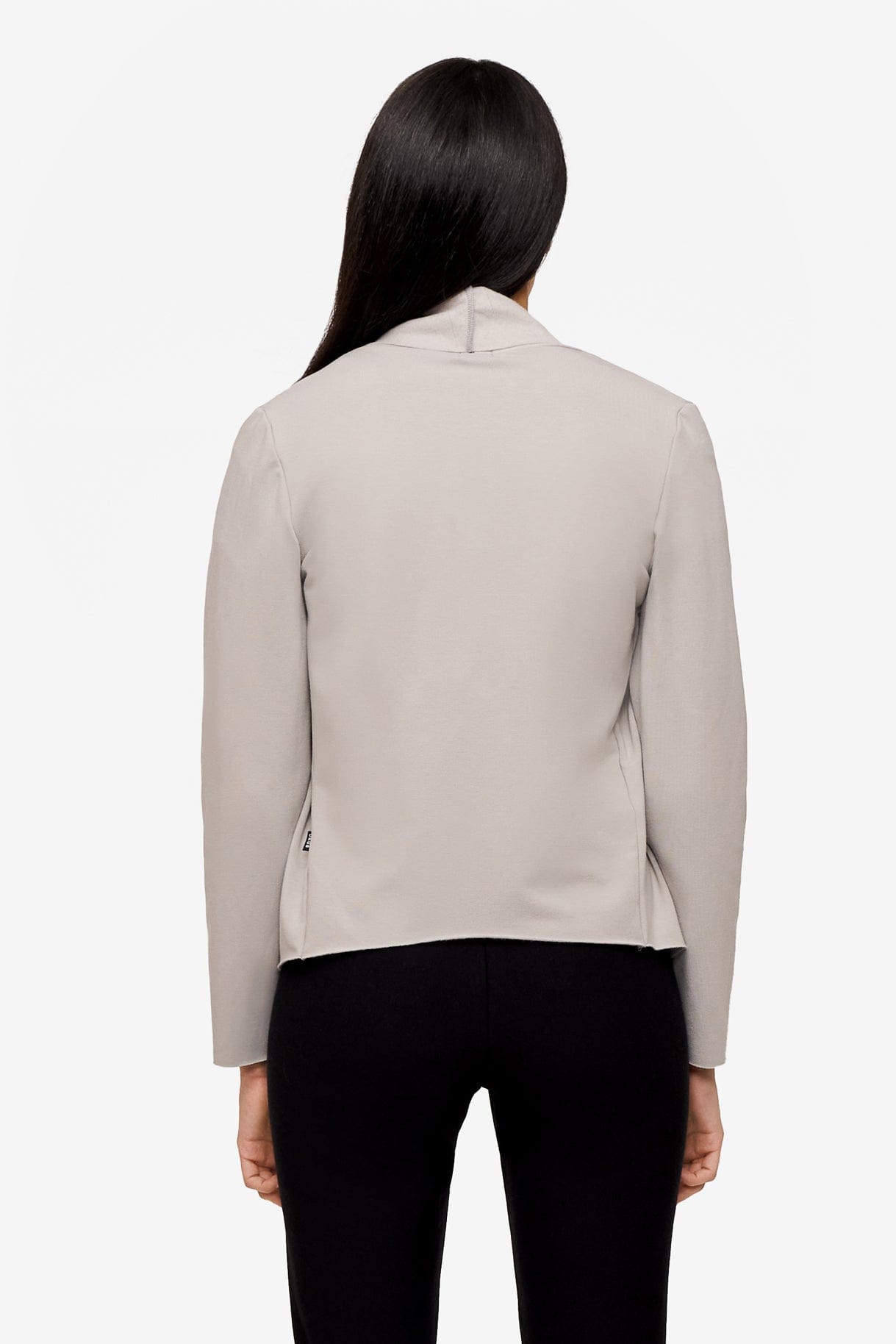 back of a woman wearing a light grey jacket