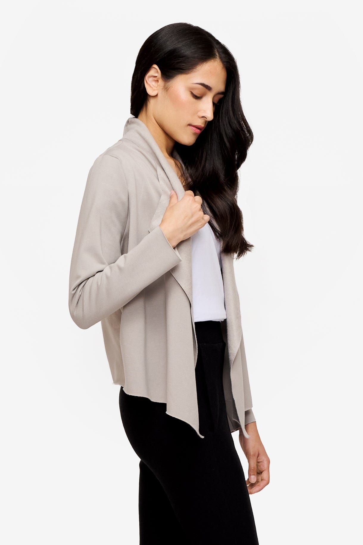 side of a woman wearing a light grey jacket