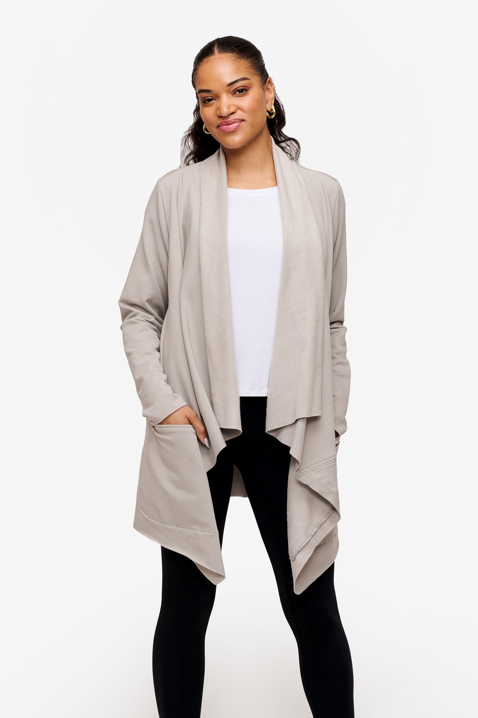 woman wearing a drapey jacket in light grey