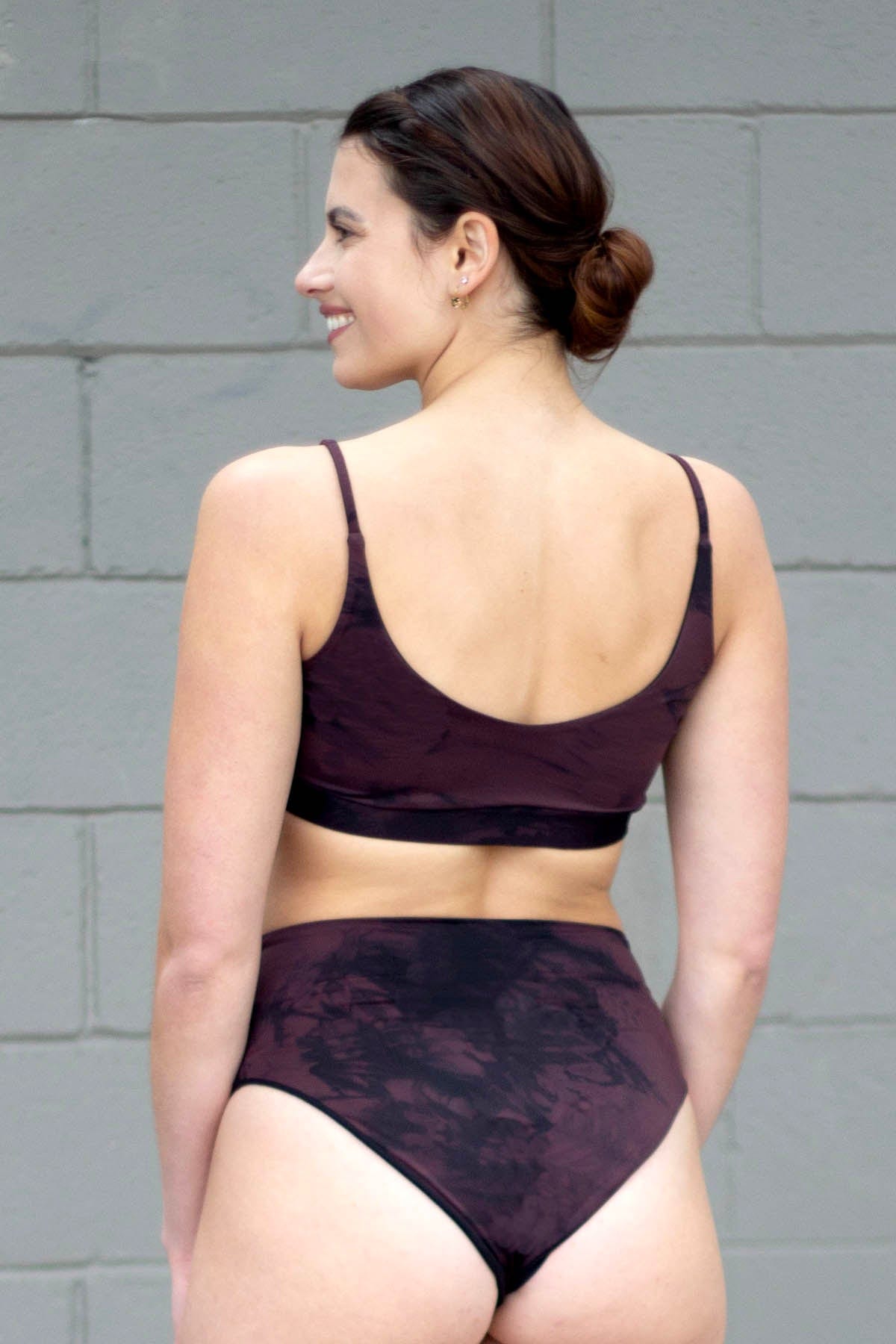 Woman wearing a brown tie-dye swim bottom and matching top