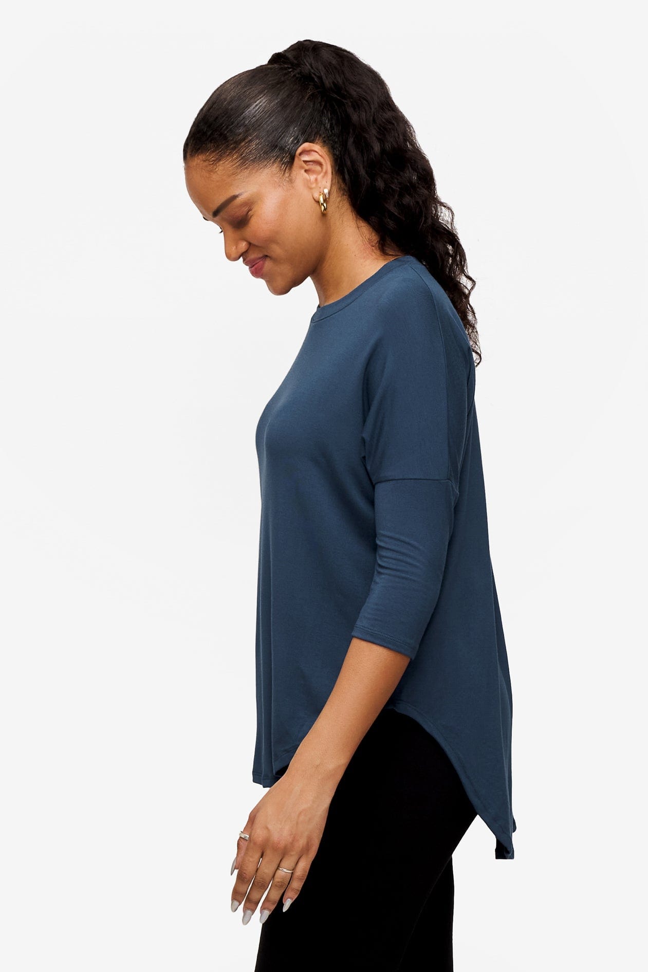 Side of a Woman wearing a bright blue 3/4 sleeve shirt