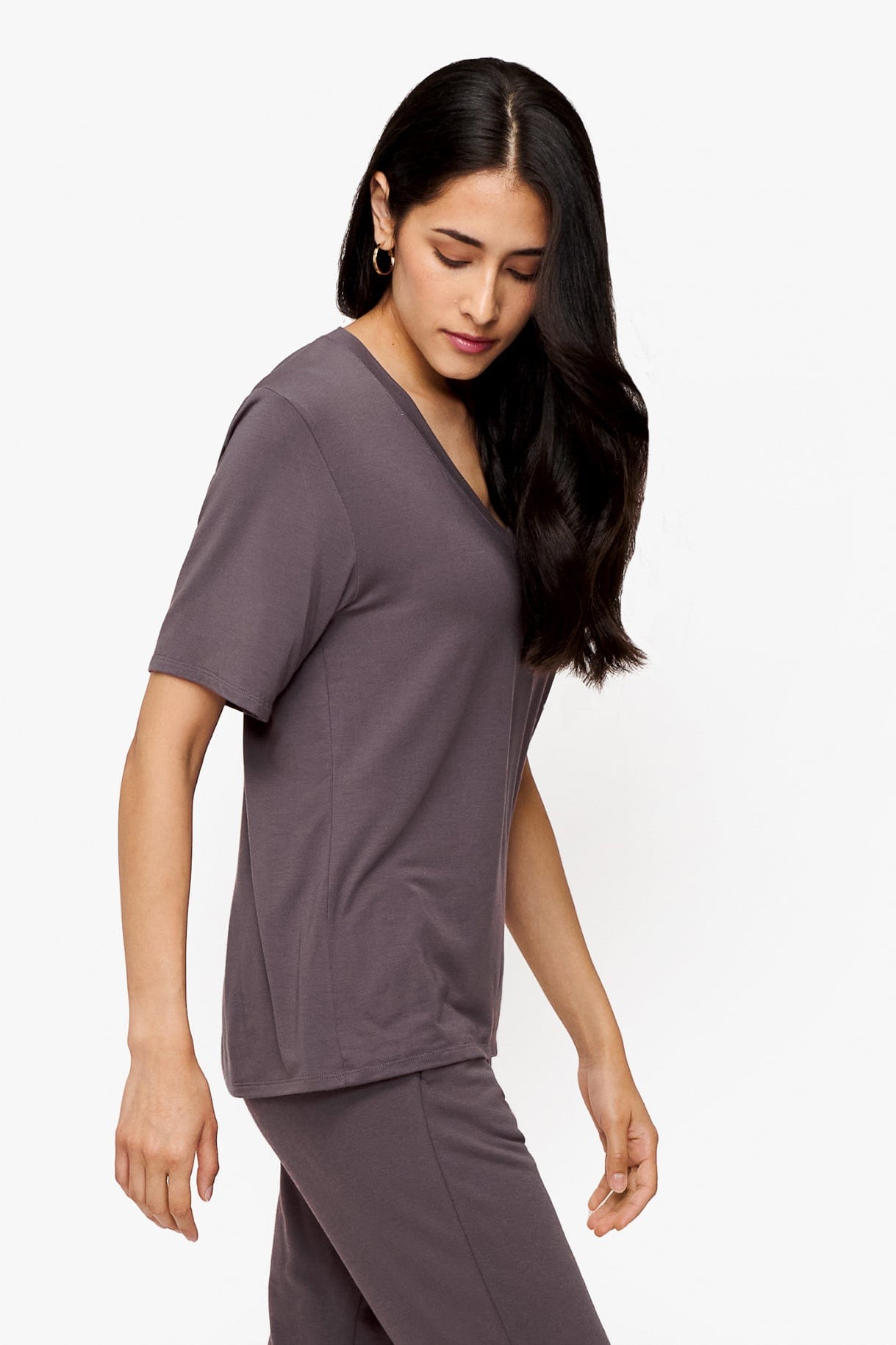 side of a woman wearing deep purple v-neck short sleeve t-shirt