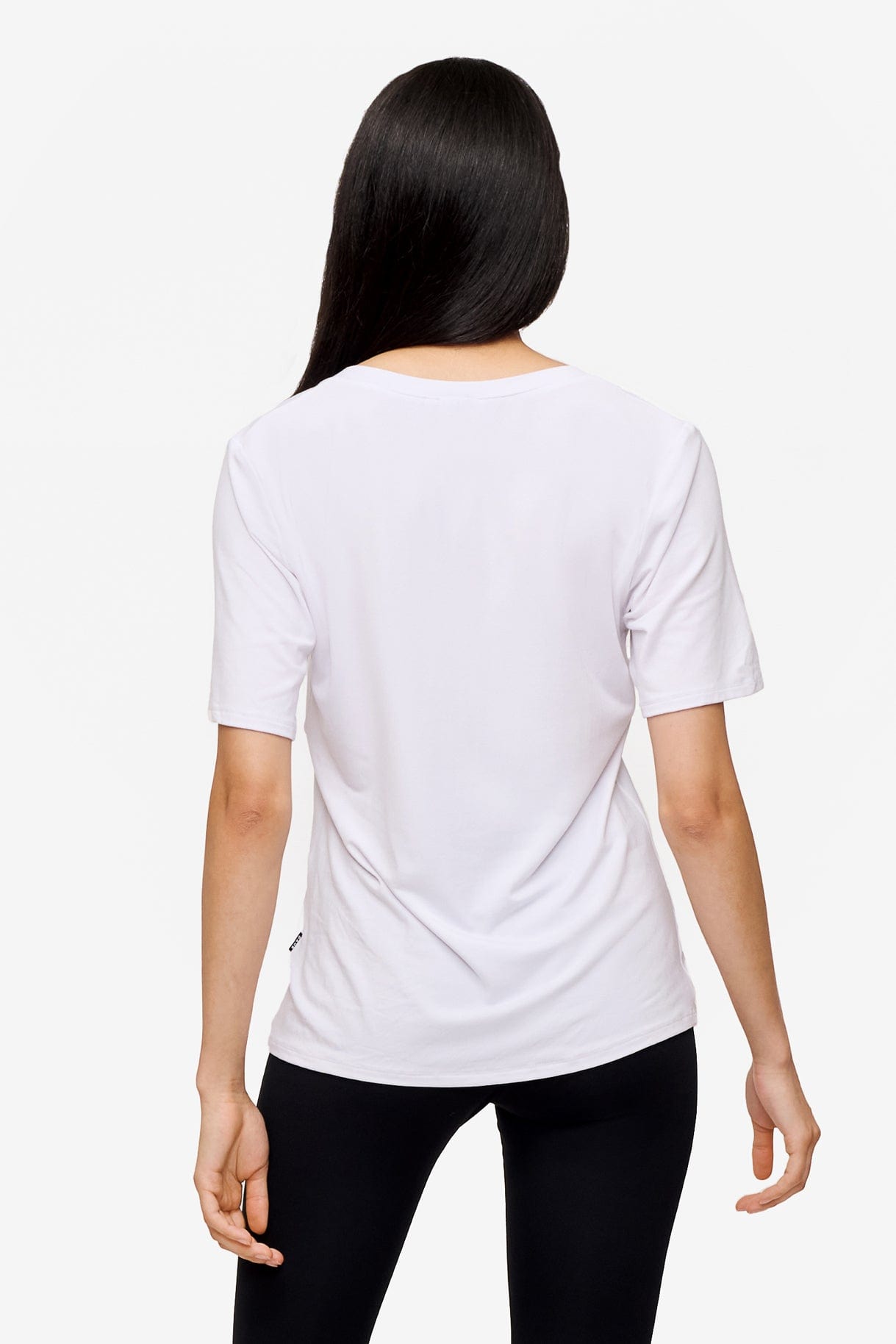 back of woman wearing white v-neck short sleeve t-shirt