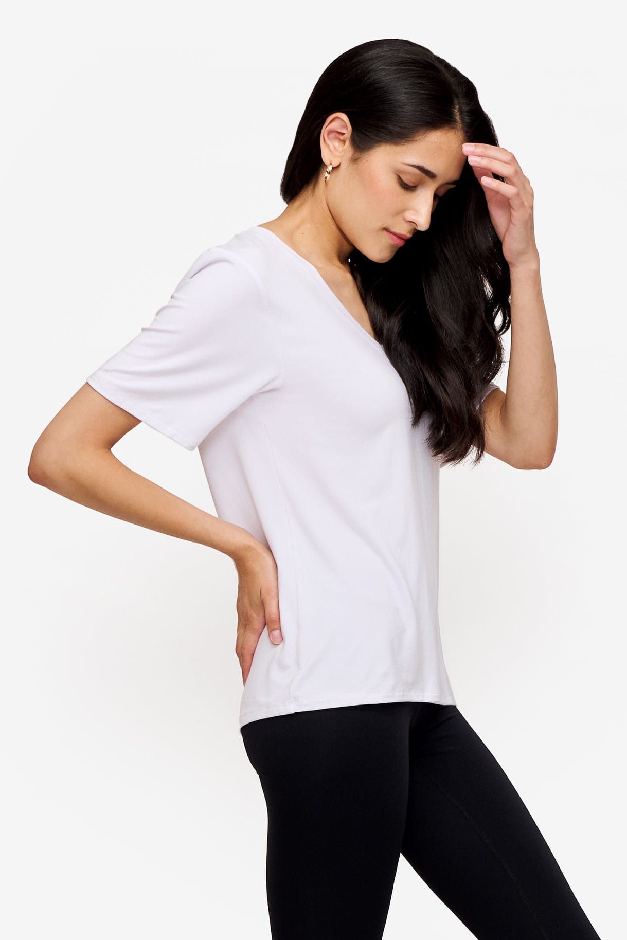 side of woman wearing white v-neck short sleeve t-shirt