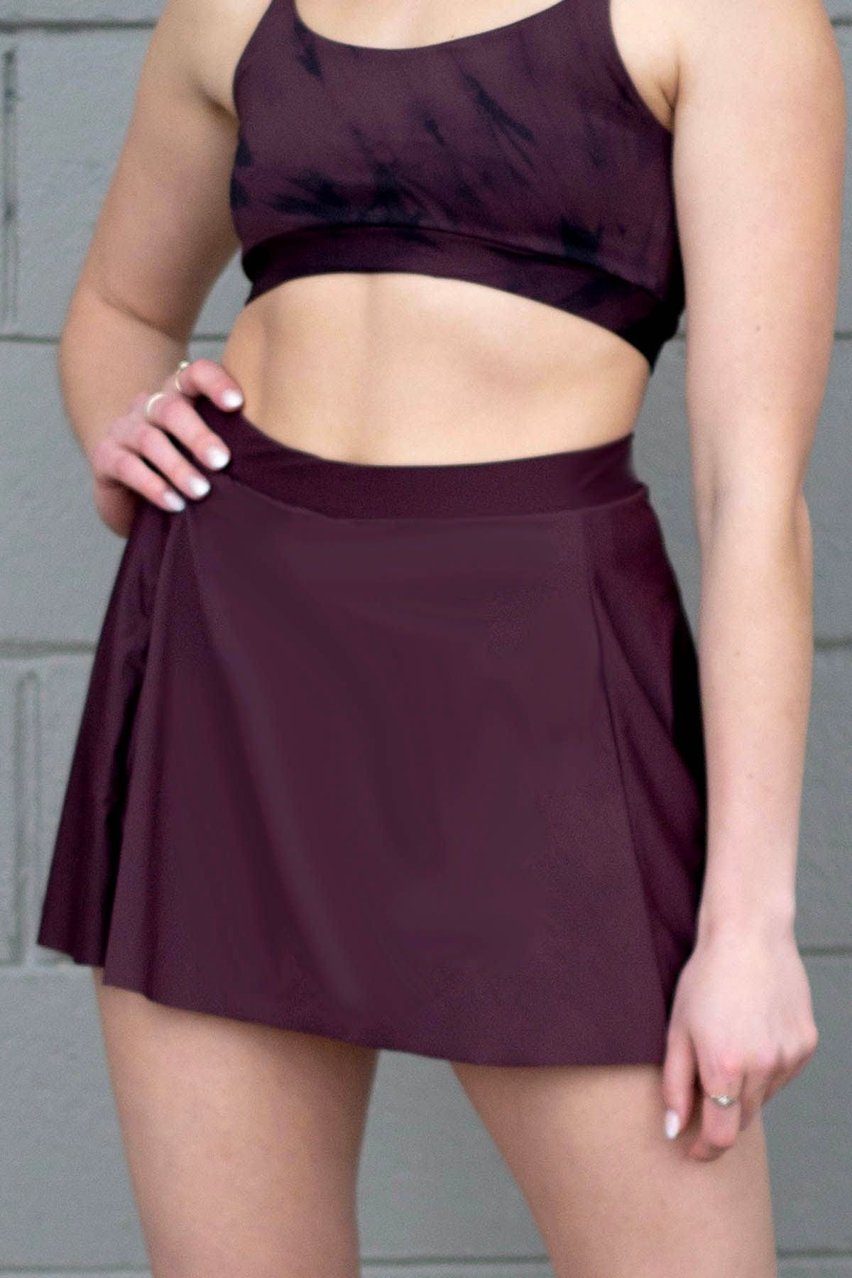 Woman wearing a tennis skirt in brown