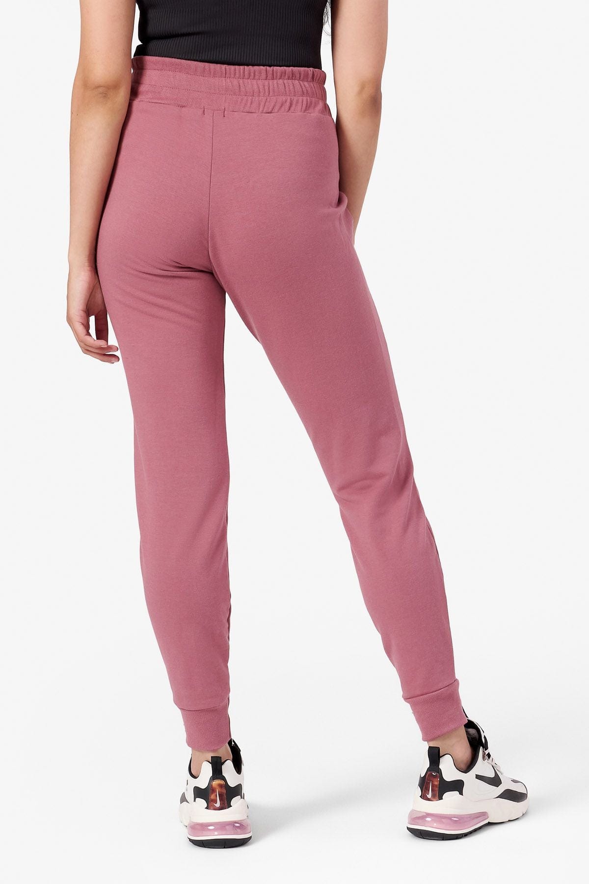 Back of a woman wearing cozy pink fleece joggers