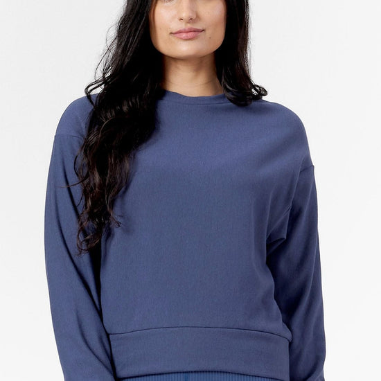 Woman wearing a blue crew neck