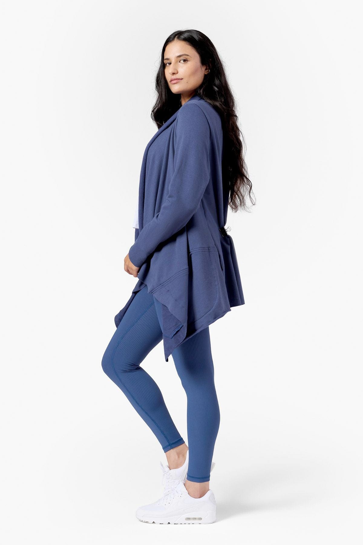 a woman wearing a drapey fleece jacket in blue