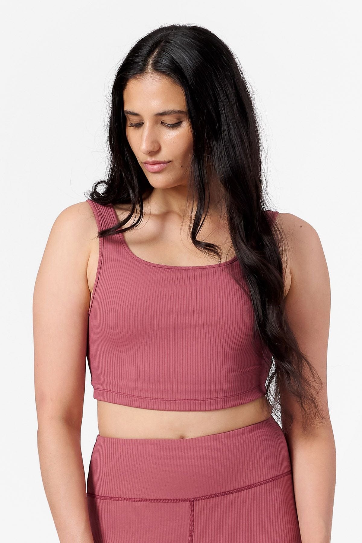 front view of a woman wearing a square neck ribbed sports bra in pink