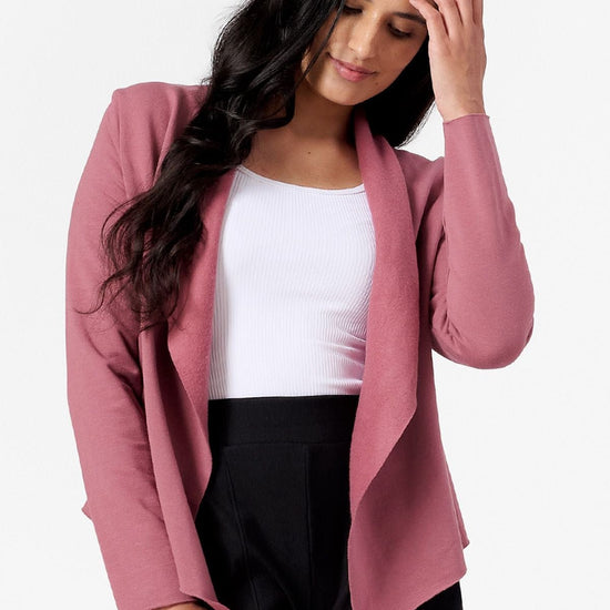 Woman smiling wearing a pink jacket