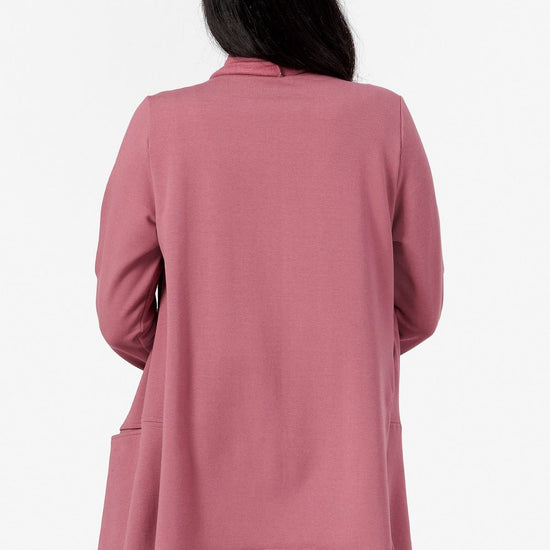 back view of a woman wearing a pink fleece jacket