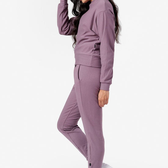 Woman wearing matching purple jogger and sweatshirt set