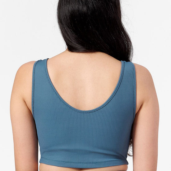 back of a women wearing round scoop neck line crop top with built in lining. 