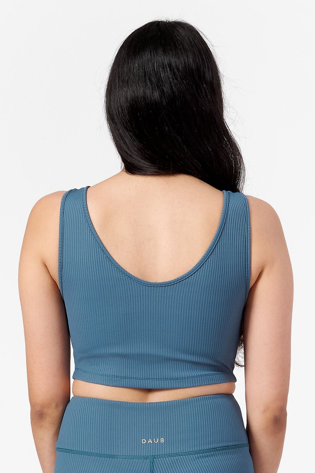 back of a women wearing round scoop neck line crop top with built in lining.