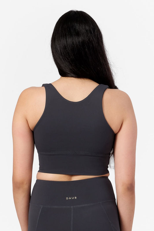 back view of a woman wearing a reveresible crop top bra in grey