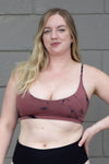 Blonde woman wearing a tie-dye swim top