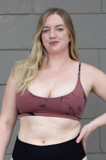 Blonde woman wearing a tie-dye swim top