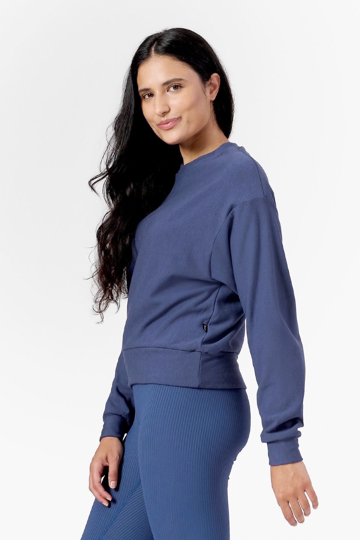 Woman smiling wearing a blue sweatshirt