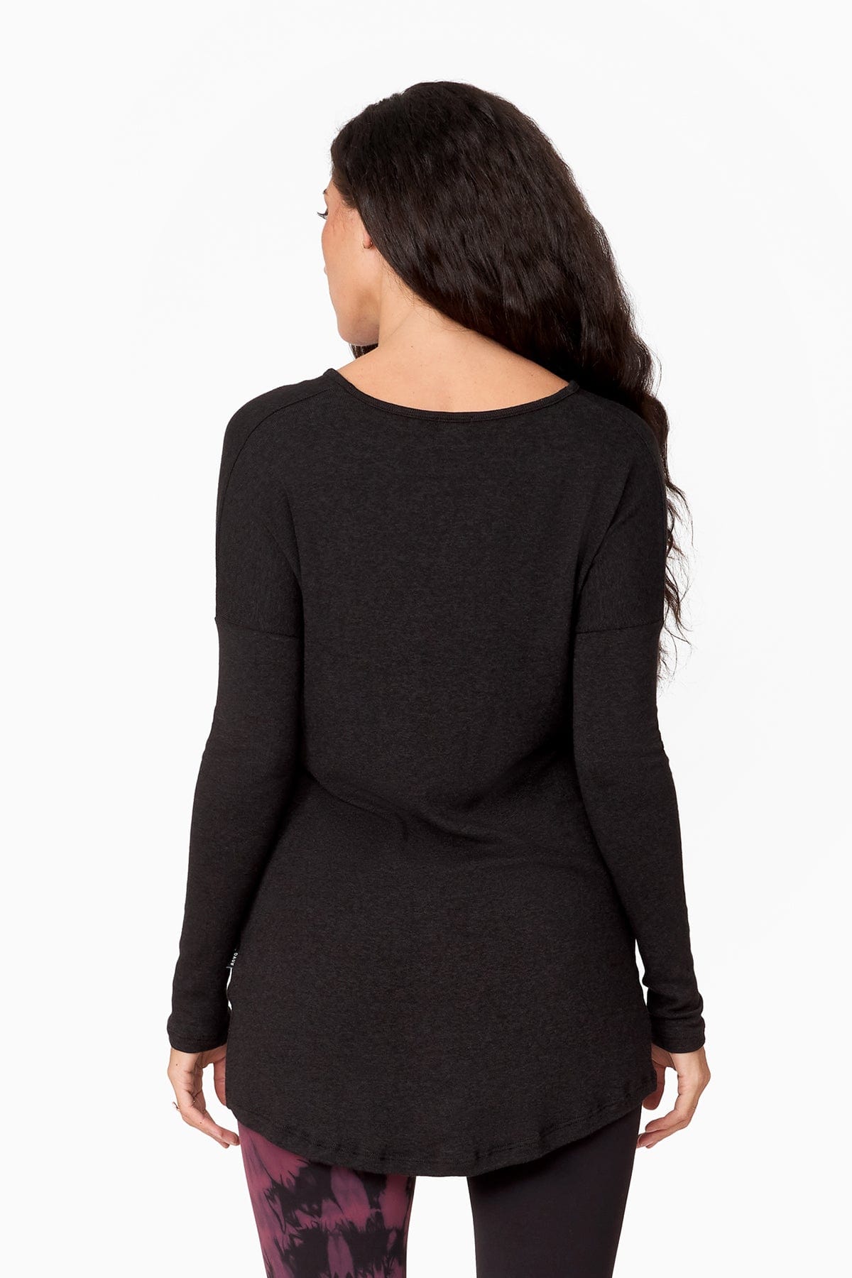 The back of a woman wearing a long longsleeve sweater.