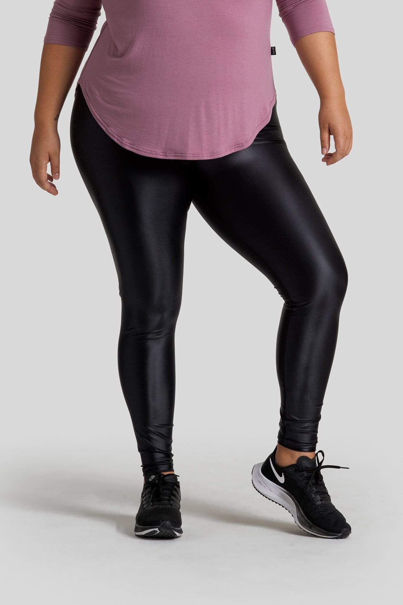 A woman's legs are shown wearing liquid black leggings