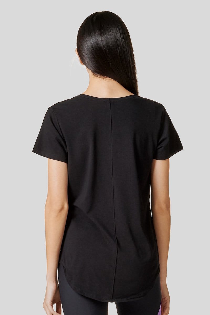 Back of a woman wearing a black short sleeve shirt