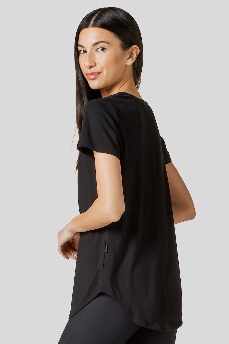 Women looking at her back wearing a black short sleeve shirt